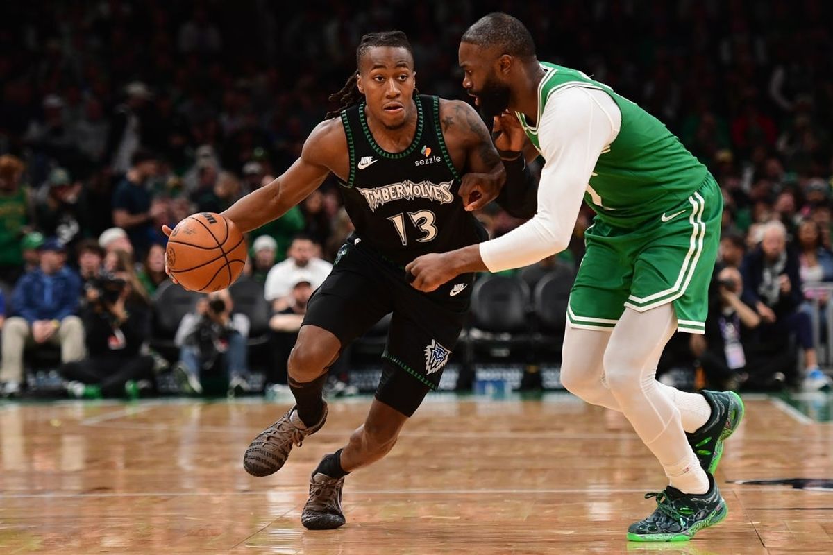 Mar 22, 2026; Boston, Massachusetts, USA;  Minnesota Timberwolves guard Ayo Dosunmu (13) controls the ball while Boston Celtics guard Jaylen Brown (7) defends during the second half at TD Garden. Mandatory Credit: Bob DeChiara-Imagn Images