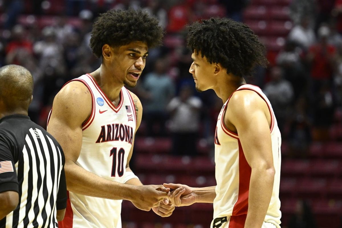 Mar 22, 2026; San Diego, CA, USA; Arizona Wildcats forward Koa Peat (10) celebrates with guard Brayden Burries (5) after defeating the Utah State Aggies during a second round game of the men's 2026 NCAA Tournament at Viejas Arena. Mandatory Credit: Denis Poroy-Imagn Images