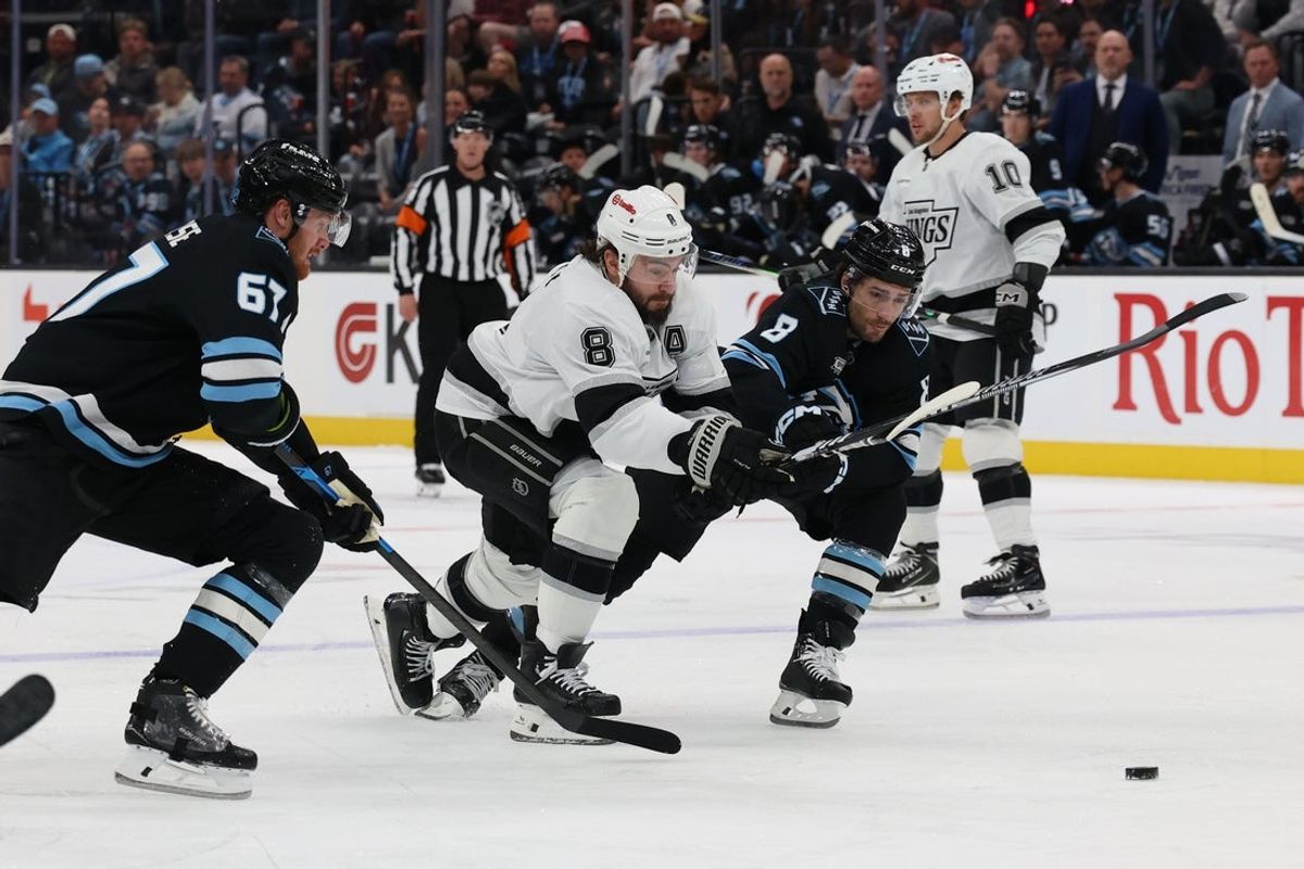 Mar 22, 2026; Salt Lake City, Utah, USA; Los Angeles Kings defenseman Drew Doughty (8) skates with the puck against Utah Mammoth center Nick Schmaltz (8) and left wing Lawson Crouse (67) during the second period at Delta Center. Mandatory Credit: Rob Gray-Imagn Images