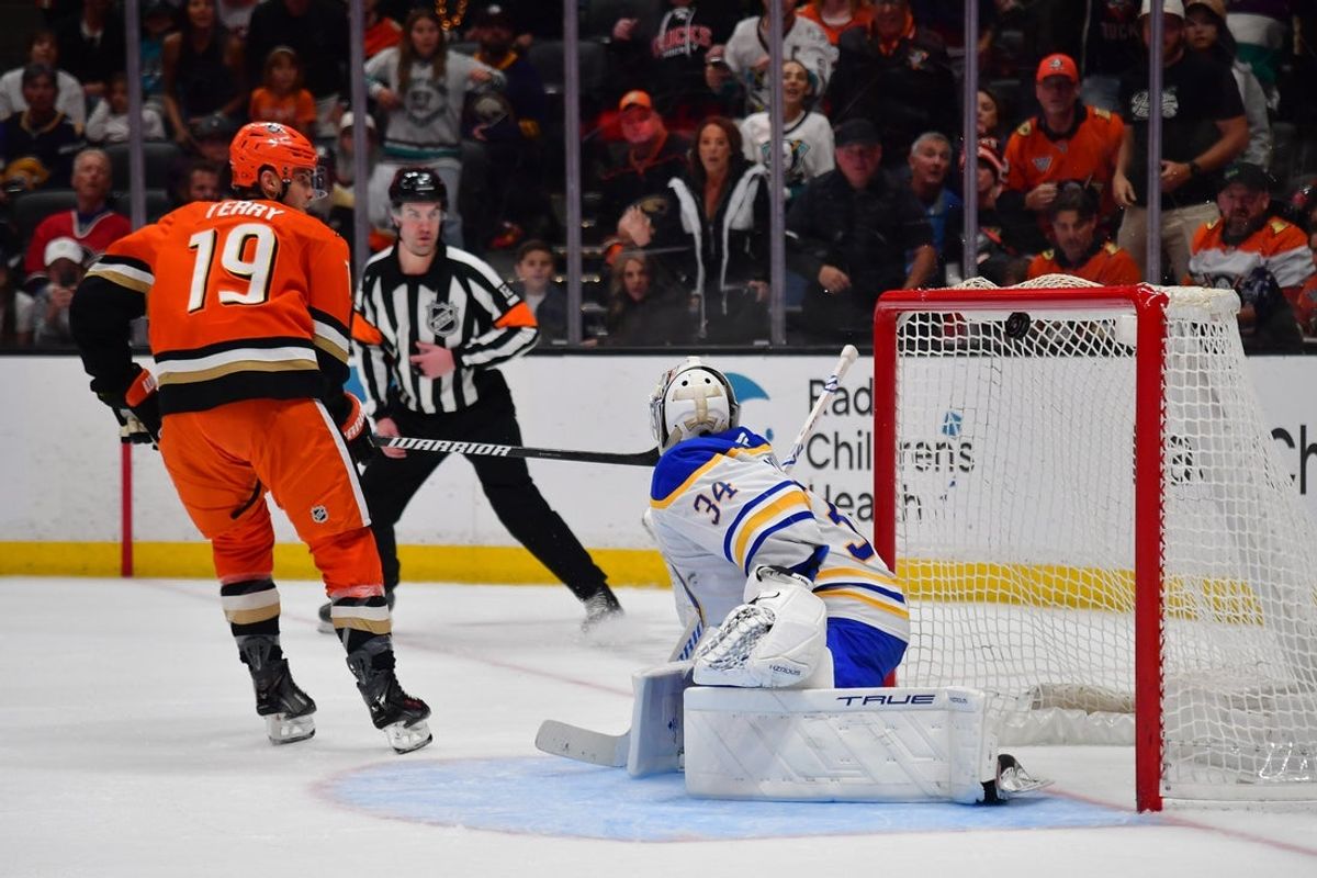Mar 22, 2026; Anaheim, California, USA; Anaheim Ducks right wing Troy Terry (19) scores a goal against Buffalo Sabres goaltender Alex Lyon (34) during the overtime period at Honda Center. Mandatory Credit: Gary A. Vasquez-Imagn Images