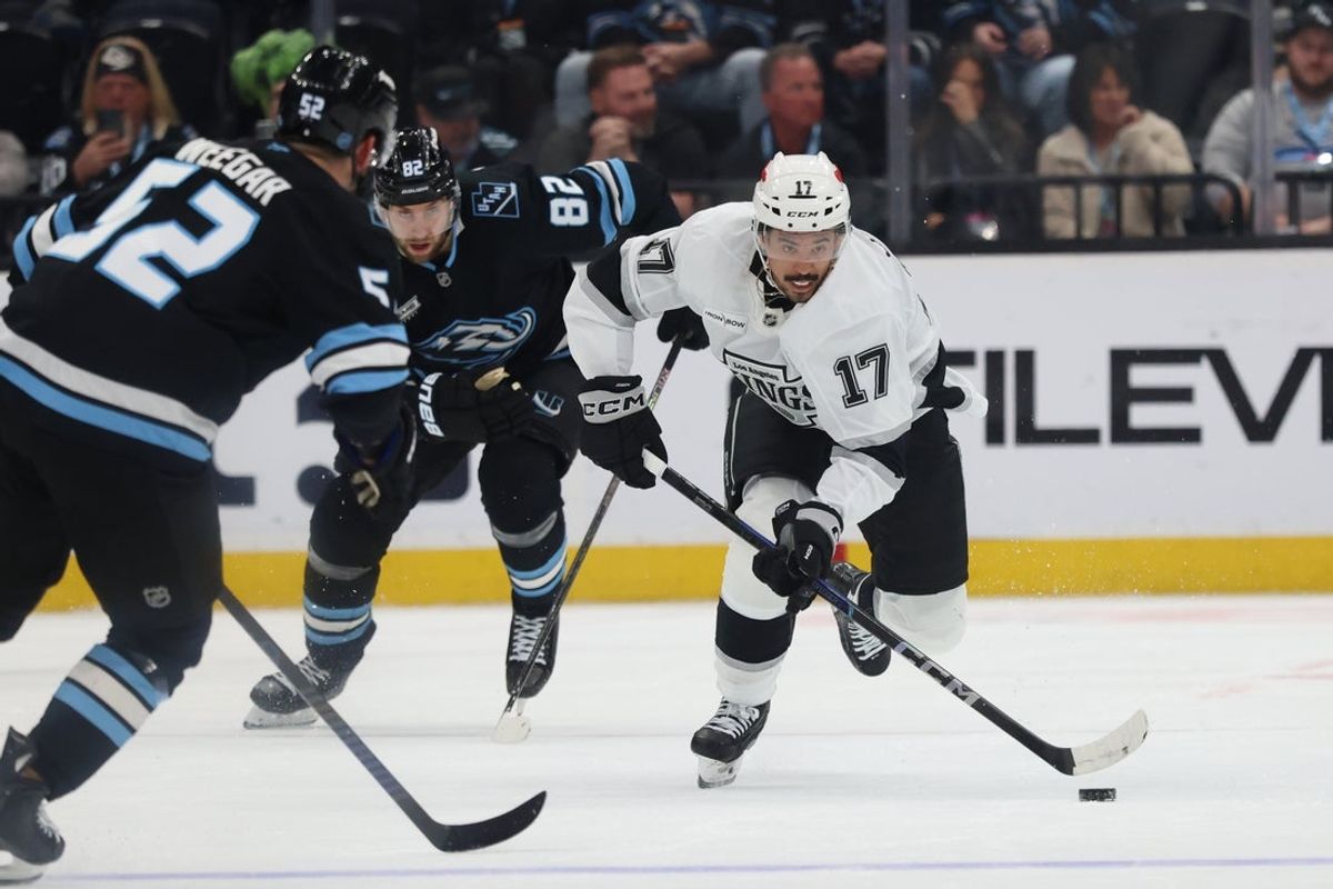 Mar 22, 2026; Salt Lake City, Utah, USA; Los Angeles Kings right wing Mathieu Joseph (17) advances the puck against Utah Mammoth center Kevin Stenlund (82) and defenseman MacKenzie Weegar (52) during the third period at Delta Center. Mandatory Credit: Rob Gray-Imagn Images