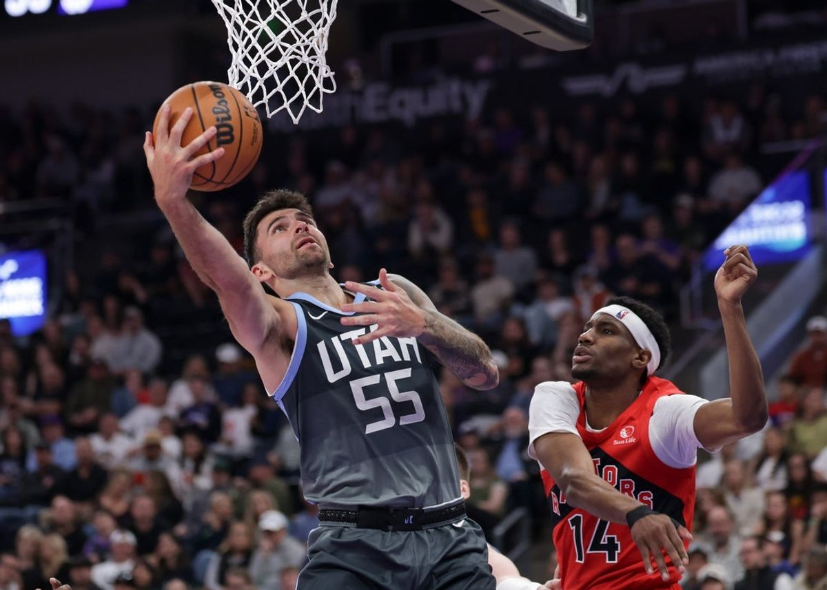 Mar 23, 2026; Salt Lake City, Utah, USA;  Utah Jazz guard John Konchar (55) goes under the basket and shoots the ball during the second quarter against the Toronto Raptors at Delta Center. Mandatory Credit: Chris Nicoll-Imagn Images