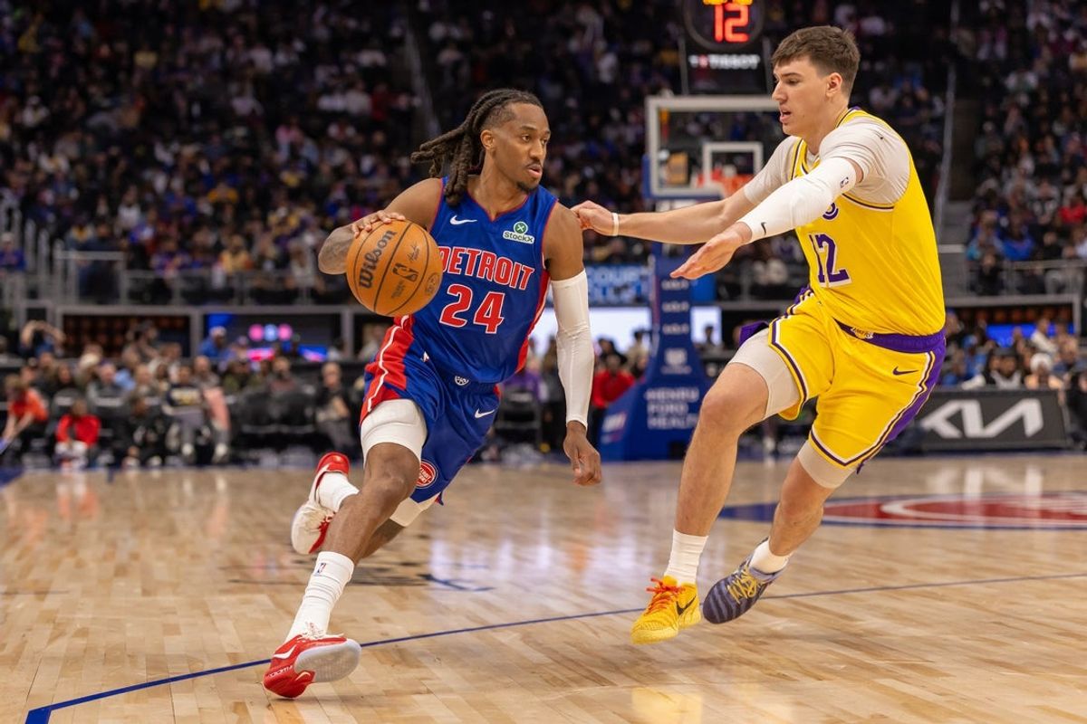 Mar 23, 2026; Detroit, Michigan, USA; Los Angeles Lakers Jake LaRavia (12) defends against Detroit Pistons Daniss Jenkins (24) during the second half at Little Caesars Arena. Mandatory Credit: David Reginek-Imagn Images