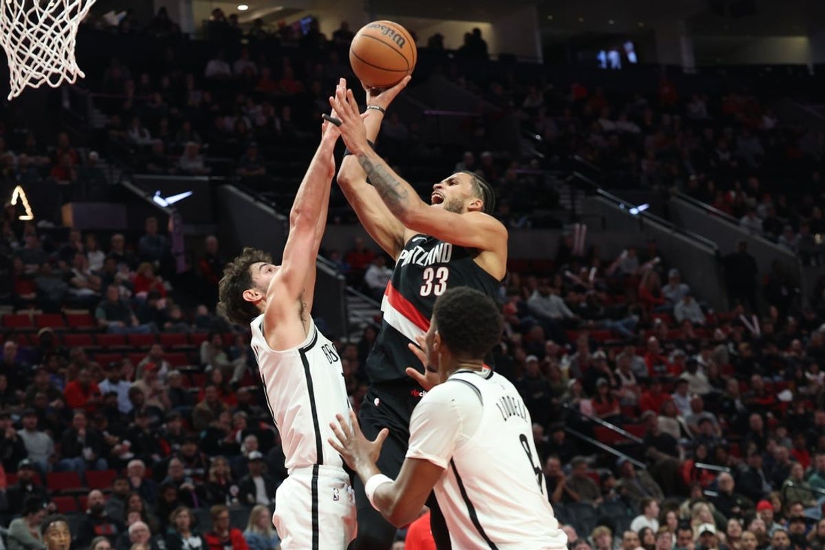 Mar 23, 2026; Portland, Oregon, USA; Portland Trail Blazers forward Toumani Camara (33) shoots the ball over Brooklyn Nets guard Ben Saraf (77) during the first half at Moda Center. Mandatory Credit: Jaime Valdez-Imagn Images