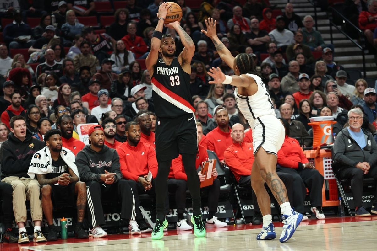 Mar 23, 2026; Portland, Oregon, USA; Portland Trail Blazers forward Toumani Camara (33) shoots the ball over Brooklyn Nets guard Tyson Etienne (10) during the first half at Moda Center. Mandatory Credit: Jaime Valdez-Imagn Images