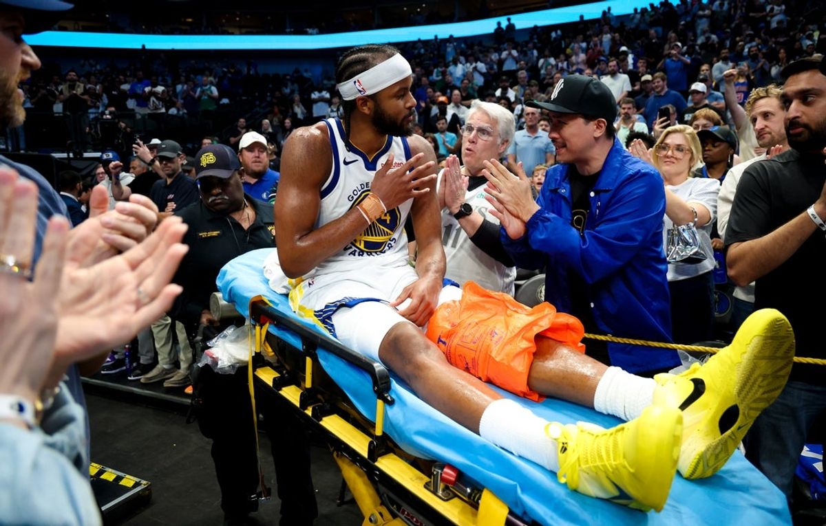 Mar 23, 2026; Dallas, Texas, USA;  Golden State Warriors guard Moses Moody (4) waves to fans while leaving the court on a stretcher during overtime against the Dallas Mavericks at American Airlines Center. Mandatory Credit: Kevin Jairaj-Imagn Images