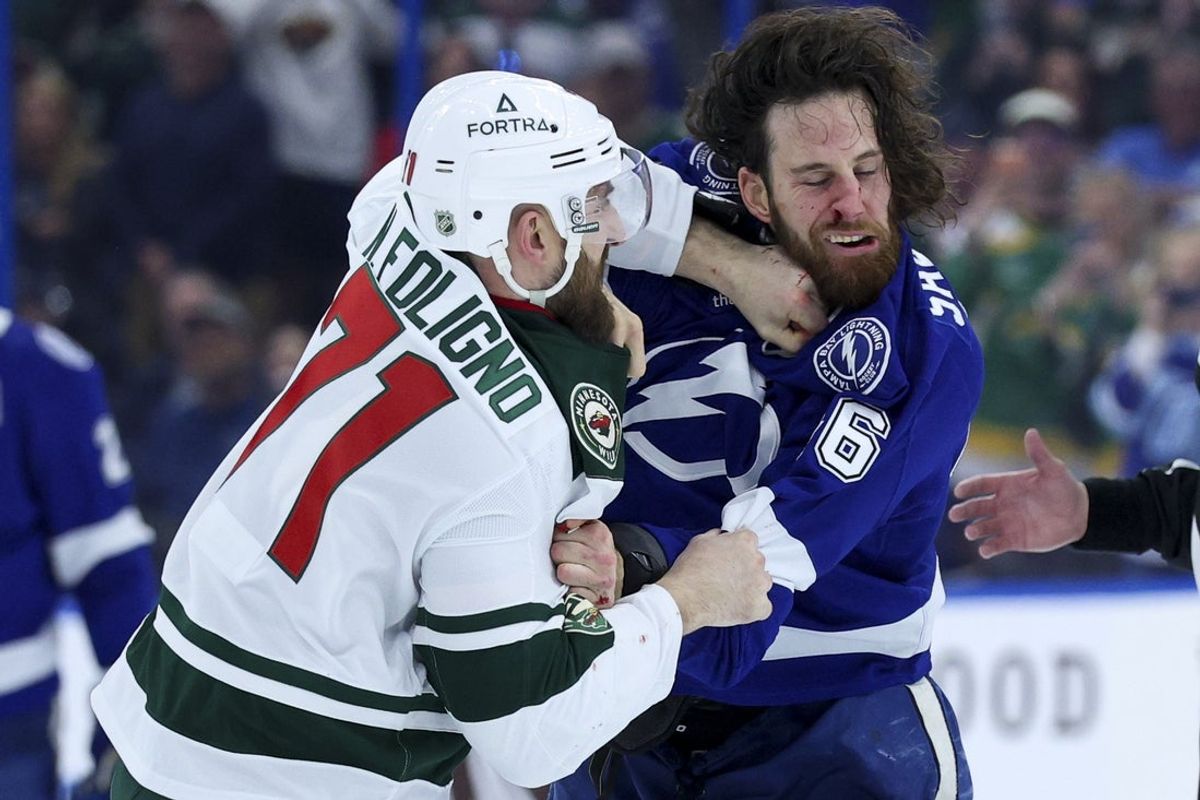 Mar 24, 2026; Tampa, Florida, USA; Tampa Bay Lightning right wing Scott Sabourin (46) and Minnesota Wild left wing Nick Foligno (71) fight in the first period at Benchmark International Arena. Mandatory Credit: Nathan Ray Seebeck-Imagn Images