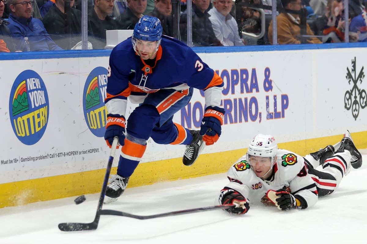 Mar 24, 2026; Elmont, New York, USA; New York Islanders defenseman Adam Pelech (3) fights for the puck against Chicago Blackhawks right wing Ilya Mikheyev (95) during the second period at UBS Arena. Mandatory Credit: Brad Penner-Imagn Images