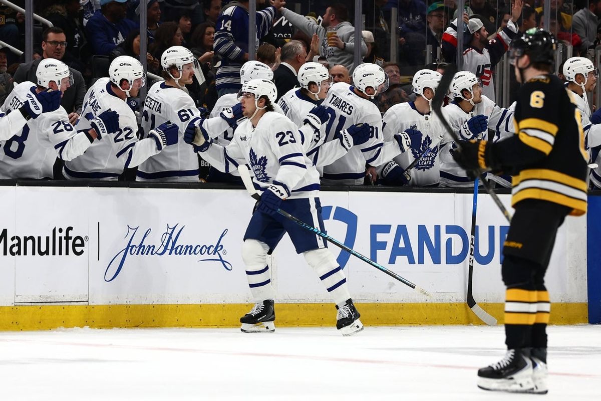 Mar 24, 2026; Boston, Massachusetts, USA; As Boston Bruins defenseman Mason Lohrei (6) heads for his bench, Toronto Maple Leafs left wing Matthew Knies (23) is congratulated at the bench after scoring a shorthanded goal during the second period at TD Garden. Mandatory Credit: Winslow Townson-Imagn Images