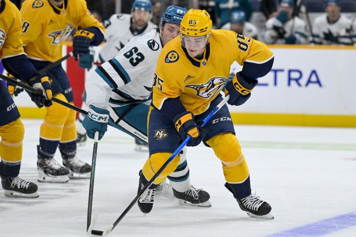 Mar 24, 2026; Nashville, Tennessee, USA;  Nashville Predators defenseman Ryan Ufko (85) grabs the loose puck against the San Jose Sharks during the second period at Bridgestone Arena. Mandatory Credit: Steve Roberts-Imagn Images