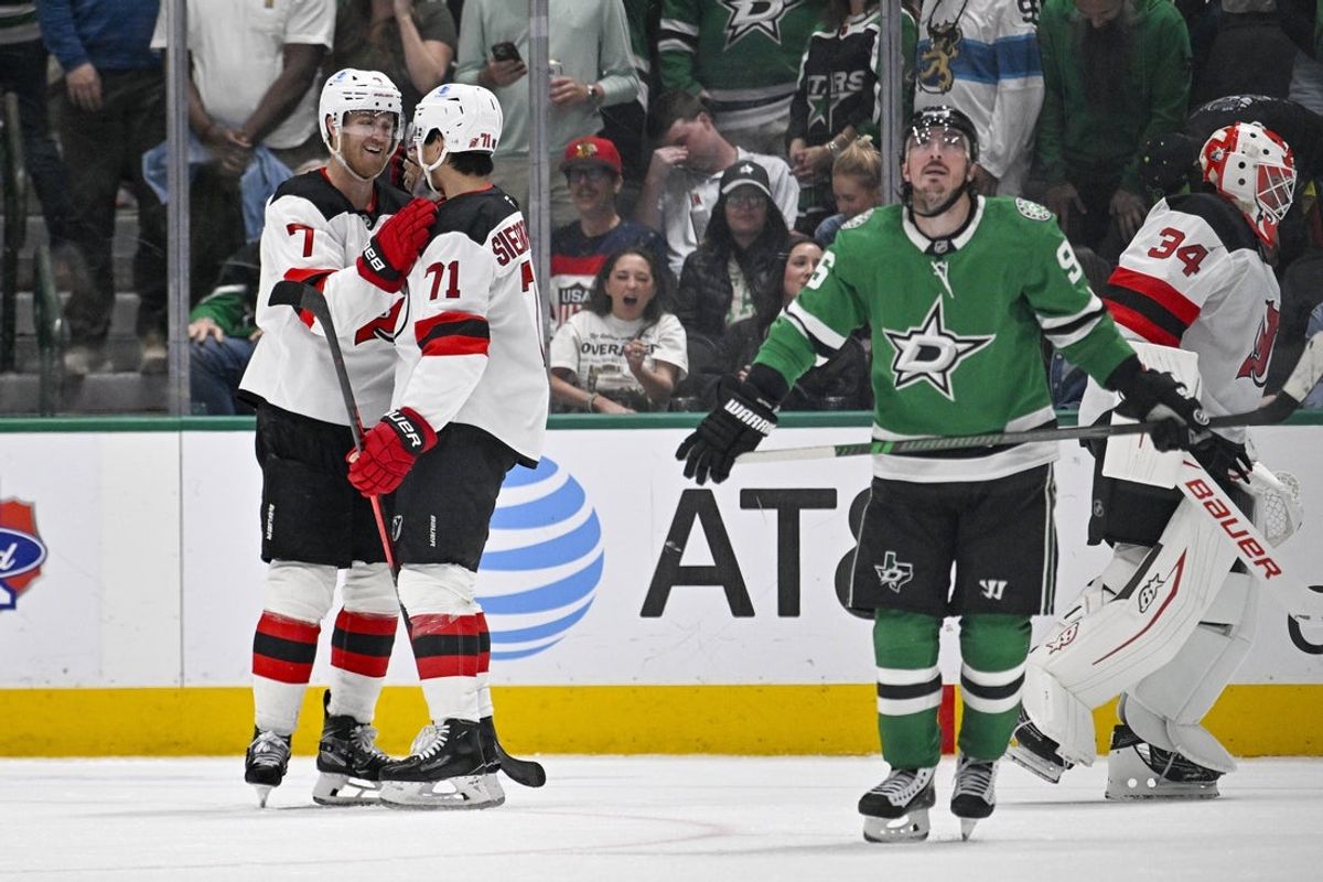 Mar 24, 2026; Dallas, Texas, USA; New Jersey Devils defenseman Dougie Hamilton (7) and defenseman Jonas Siegenthaler (71) celebrates an empty net goal scored by Hamilton against the Dallas Stars during the third period at the American Airlines Center. Mandatory Credit: Jerome Miron-Imagn Images
