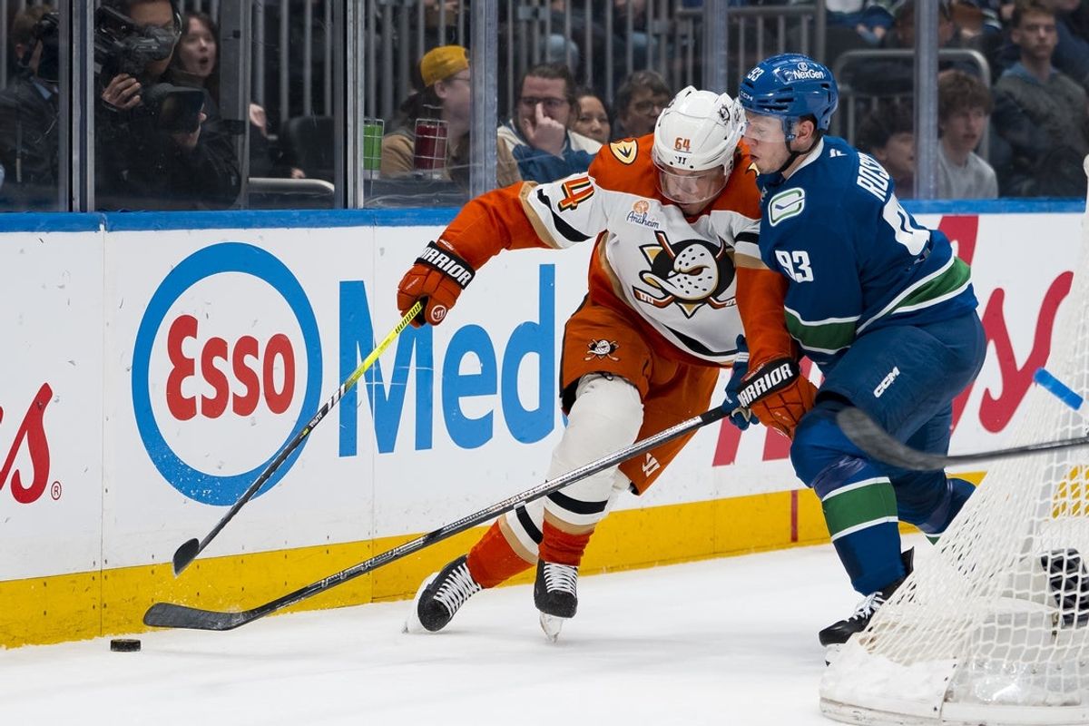 Mar 24, 2026; Vancouver, British Columbia, CAN; Vancouver Canucks forward Marco Rossi (93) checks Anaheim Ducks forward Mikael Granlund (64) in the first period at Rogers Arena. Mandatory Credit: Bob Frid-Imagn Images