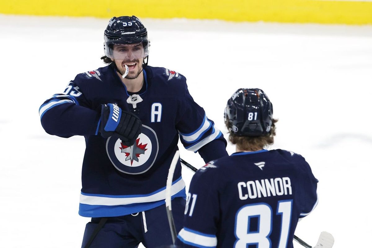 Mar 24, 2026; Winnipeg, Manitoba, CAN; Winnipeg Jets center Mark Scheifele (55) celebrates a goal against the Vegas Golden Knights with Winnipeg Jets left wing Kyle Connor (81) in the third period at Canada Life Centre. Mandatory Credit: James Carey Lauder-Imagn Images