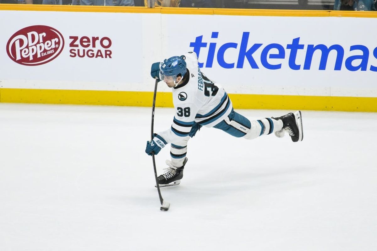 Mar 24, 2026; Nashville, Tennessee, USA;  San Jose Sharks defenseman Mario Ferraro (38) takes a shot on goal against the Nashville Predators during the third period at Bridgestone Arena. Mandatory Credit: Steve Roberts-Imagn Images