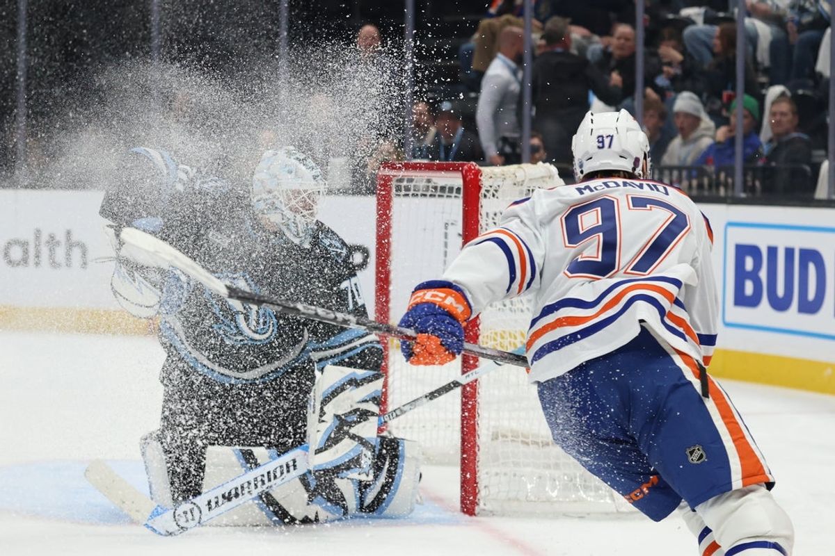 Mar 24, 2026; Salt Lake City, Utah, USA; Edmonton Oilers center Connor McDavid (97) scores a goal on Utah Mammoth goaltender Karel Vejmelka (70) during the second period at Delta Center. Mandatory Credit: Rob Gray-Imagn Images