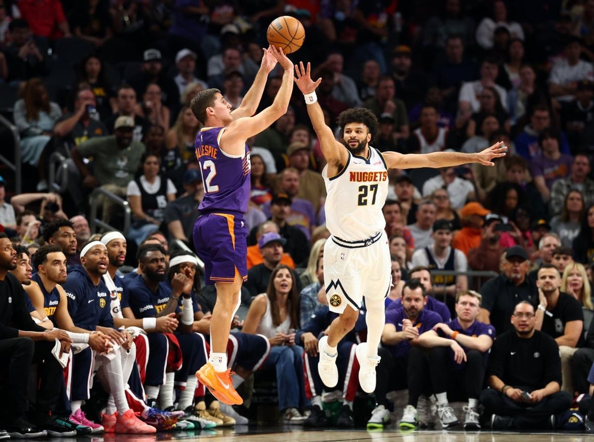 Mar 24, 2026; Phoenix, Arizona, USA; Phoenix Suns guard Collin Gillespie (12) shoots the ball against Denver Nuggets guard Jamal Murray (27) in the first half at Mortgage Matchup Center. Mandatory Credit: Mark J. Rebilas-Imagn Images
