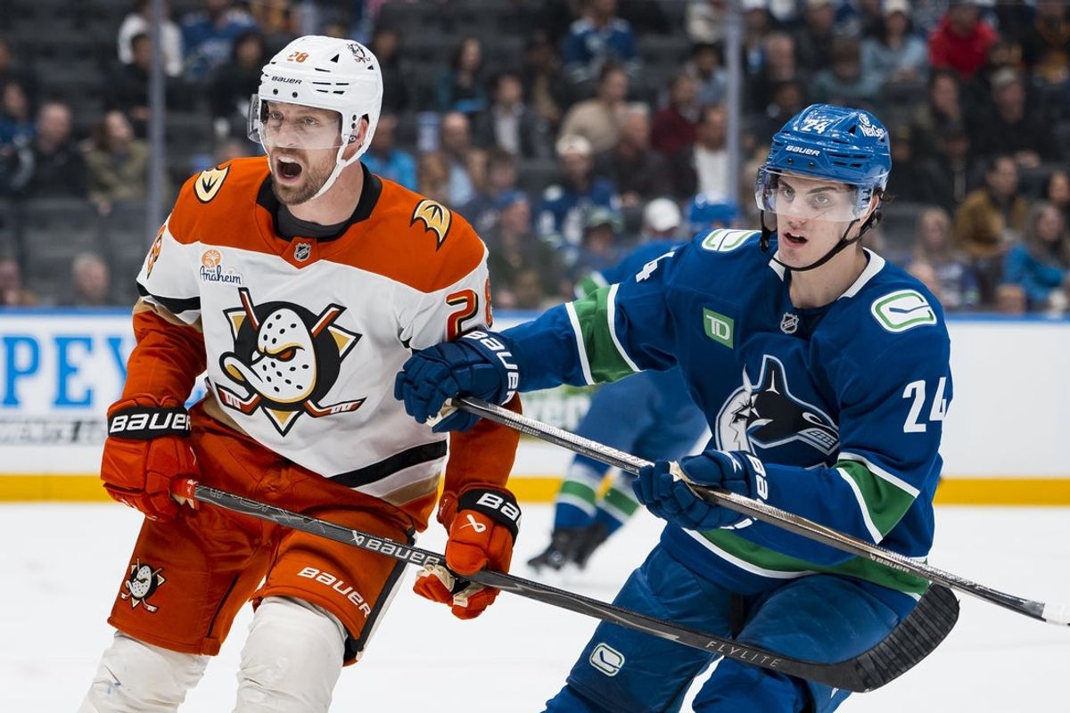 Mar 24, 2026; Vancouver, British Columbia, CAN; Anaheim Ducks forward Jeffrey Viel (28) battles with Vancouver Canucks defenseman Zeev Buium (24) in the third period at Rogers Arena. Mandatory Credit: Bob Frid-Imagn Images