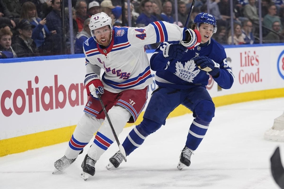 Mar 25, 2026; Toronto, Ontario, CAN; New York Rangers defenseman Vladislav Gavrikov (44) and Toronto Maple Leafs forward Easton Cowan (53) battle for position during the first period at Scotiabank Arena. Mandatory Credit: John E. Sokolowski-Imagn Images