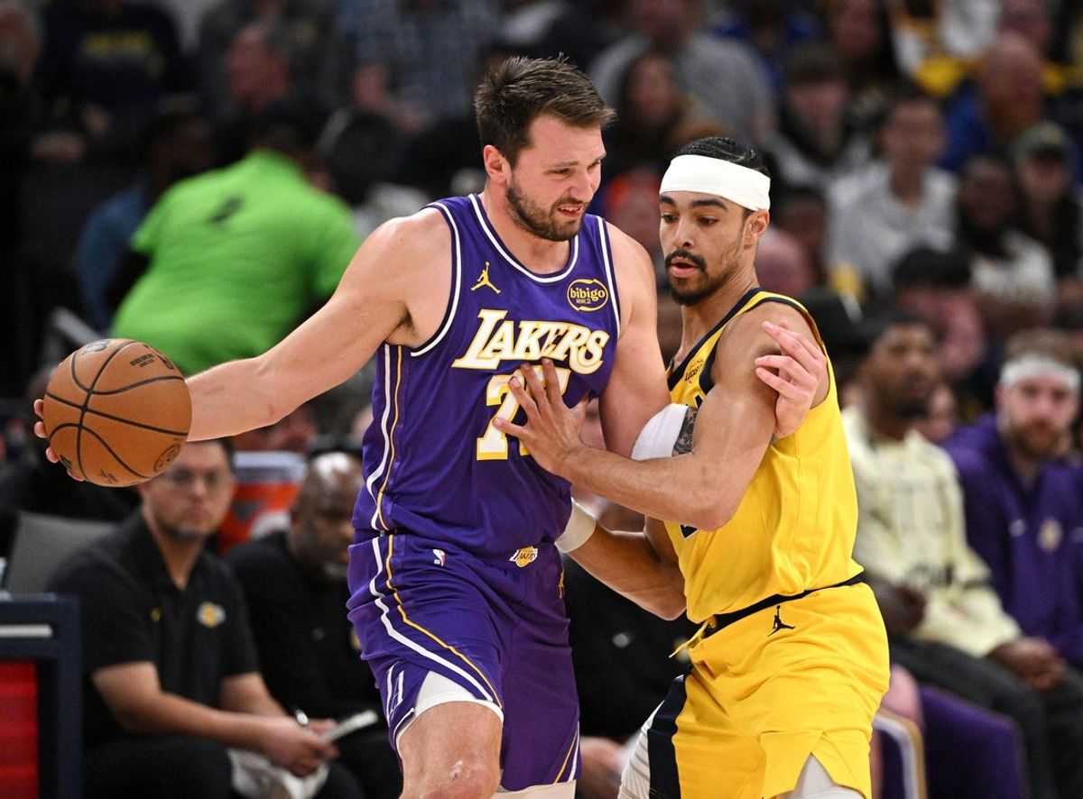 Mar 25, 2026; Indianapolis, Indiana, USA; Indiana Pacers guard Andrew Nembhard (2) defends against Los Angeles Lakers guard Luka Doncic (77) during the first quarter at Gainbridge Fieldhouse. Mandatory Credit: Marc Lebryk-Imagn Images