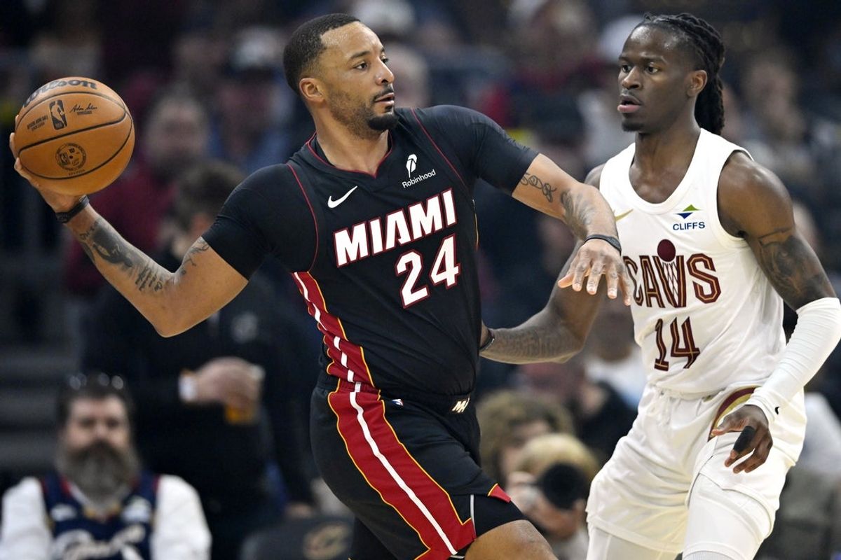 Mar 25, 2026; Cleveland, Ohio, USA; Miami Heat guard Norman Powell (24) looks to pass beside Cleveland Cavaliers guard Keon Ellis (14) in the third quarter at Rocket Arena. Mandatory Credit: David Richard-Imagn Images
