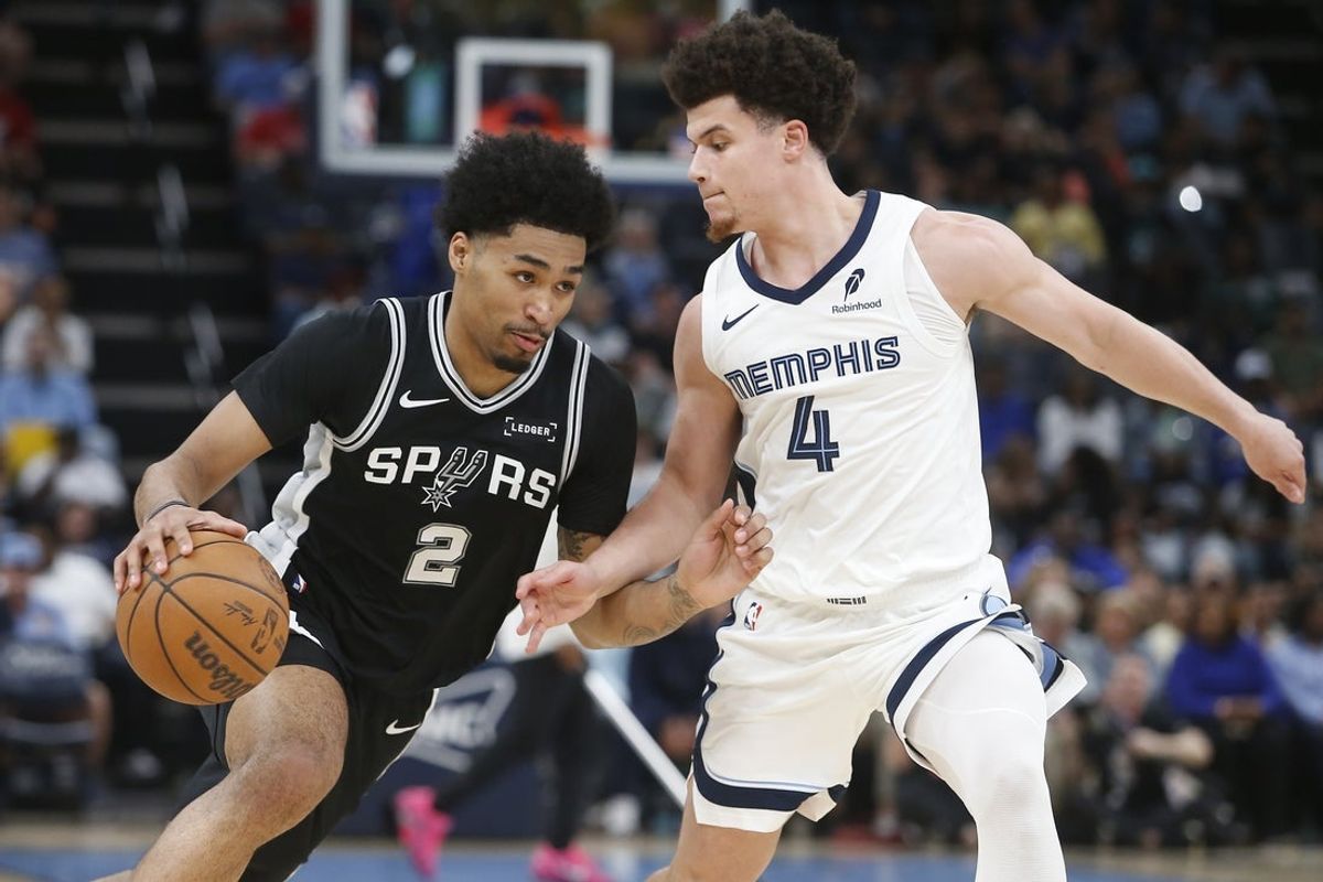 Mar 25, 2026; Memphis, Tennessee, USA; San Antonio Spurs guard Dylan Harper (2) drives to the basket as Memphis Grizzlies guard Walter Clayton Jr. (4) defends during the second quarter at FedExForum. Mandatory Credit: Petre Thomas-Imagn Images