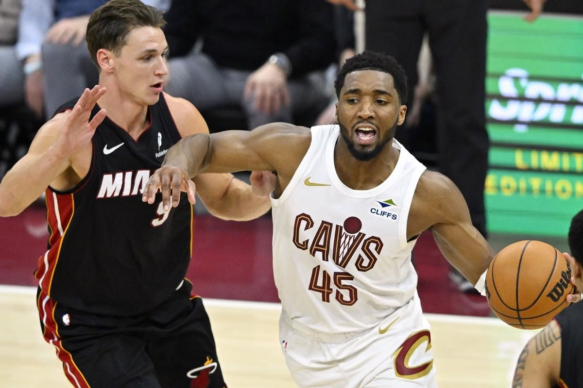 Mar 25, 2026; Cleveland, Ohio, USA; Miami Heat guard Pelle Larsson (9) defends Cleveland Cavaliers guard Donovan Mitchell (45) in the fourth quarter at Rocket Arena. Mandatory Credit: David Richard-Imagn Images