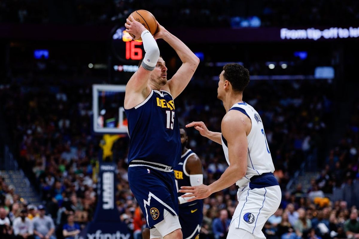 Mar 25, 2026; Denver, Colorado, USA; Denver Nuggets center Nikola Jokic (15) controls the ball as Dallas Mavericks forward Dwight Powell (7) guards in the second quarter at Ball Arena. Mandatory Credit: Isaiah J. Downing-Imagn Images