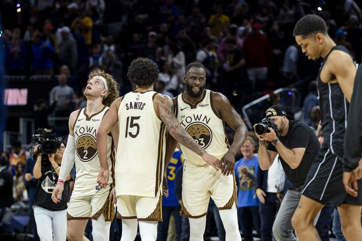 Mar 25, 2026; San Francisco, California, USA; Golden State Warriors guard Brandin Podziemski (2) and forward Gui Santos (15)  and forward Draymond Green (23) celebrate after their team defeated the Brooklyn Nets at Chase Center. Mandatory Credit: John Hefti-Imagn Images