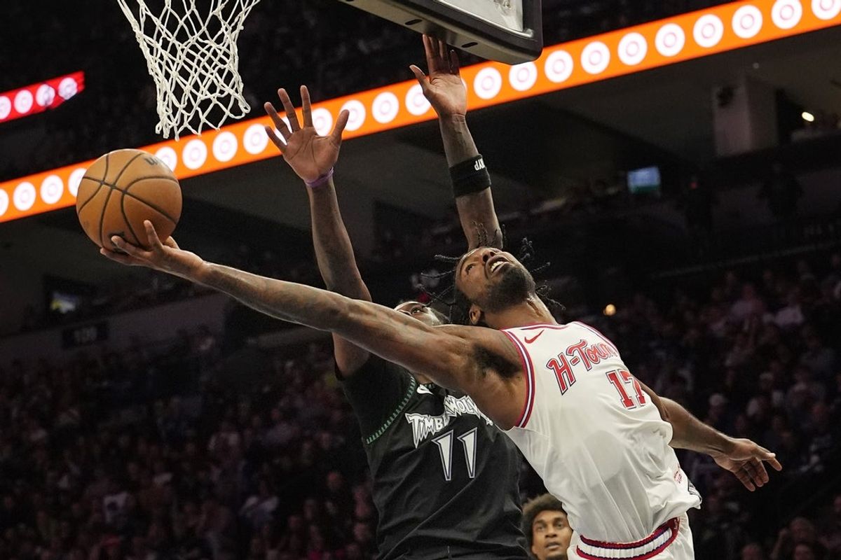 Mar 25, 2026; Minneapolis, Minnesota, USA; Houston Rockets forward Tari Eason (17) goes to the basket against Minnesota Timberwolves center Naz Reid (11) in the third quarter at Target Center. Mandatory Credit: Bruce Kluckhohn-Imagn Images