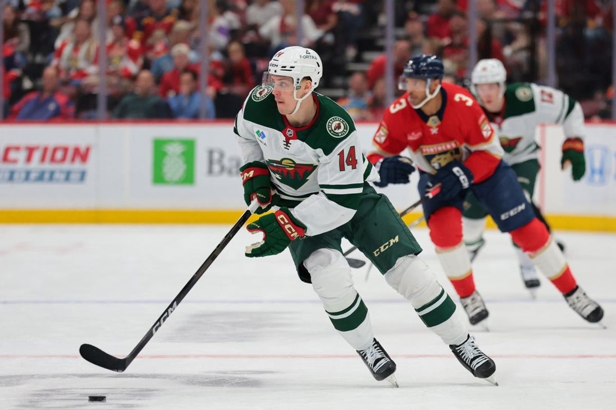 Mar 26, 2026; Sunrise, Florida, USA; Minnesota Wild center Joel Eriksson Ek (14) moves the puck against the Florida Panthers during the first period at Amerant Bank Arena. Mandatory Credit: Sam Navarro-Imagn Images