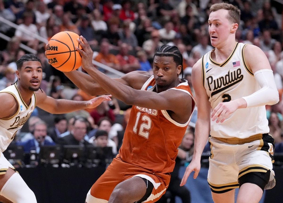 Purdue Boilermakers guard Fletcher Loyer (2) defends Texas Longhorns guard Tramon Mark (12) on Thursday, March 26, 2026, during a Sweet 16 game at SAP Center in San Jose, Calif.