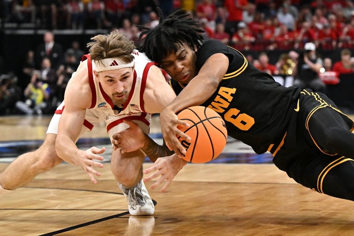 Mar 26, 2026; Houston, TX, USA; Nebraska Cornhuskers guard Sam Hoiberg (1) and Iowa Hawkeyes guard Tavion Banks (6) dive for a loose ball in the first half during a Sweet Sixteen game of the South Regional of the men's 2026 NCAA Tournament at Toyota Center. Mandatory Credit: Maria Lysaker-Imagn Images