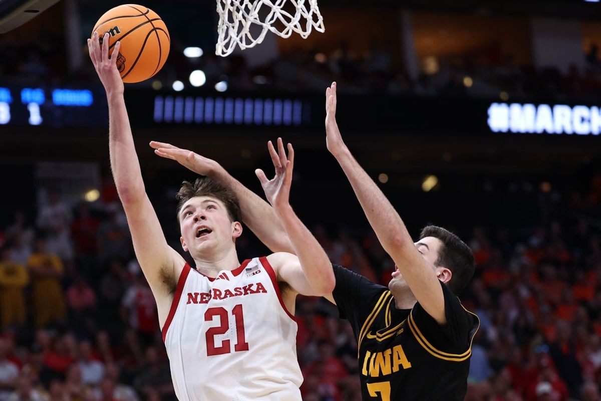 Mar 26, 2026; Houston, TX, USA; Nebraska Cornhuskers forward Pryce Sandfort (21) shoots the ball past Iowa Hawkeyes forward Alvaro Folgueiras (7) in the second half during a Sweet Sixteen game of the South Regional of the men's 2026 NCAA Tournament at Toyota Center. Mandatory Credit: Troy Taormina-Imagn Images