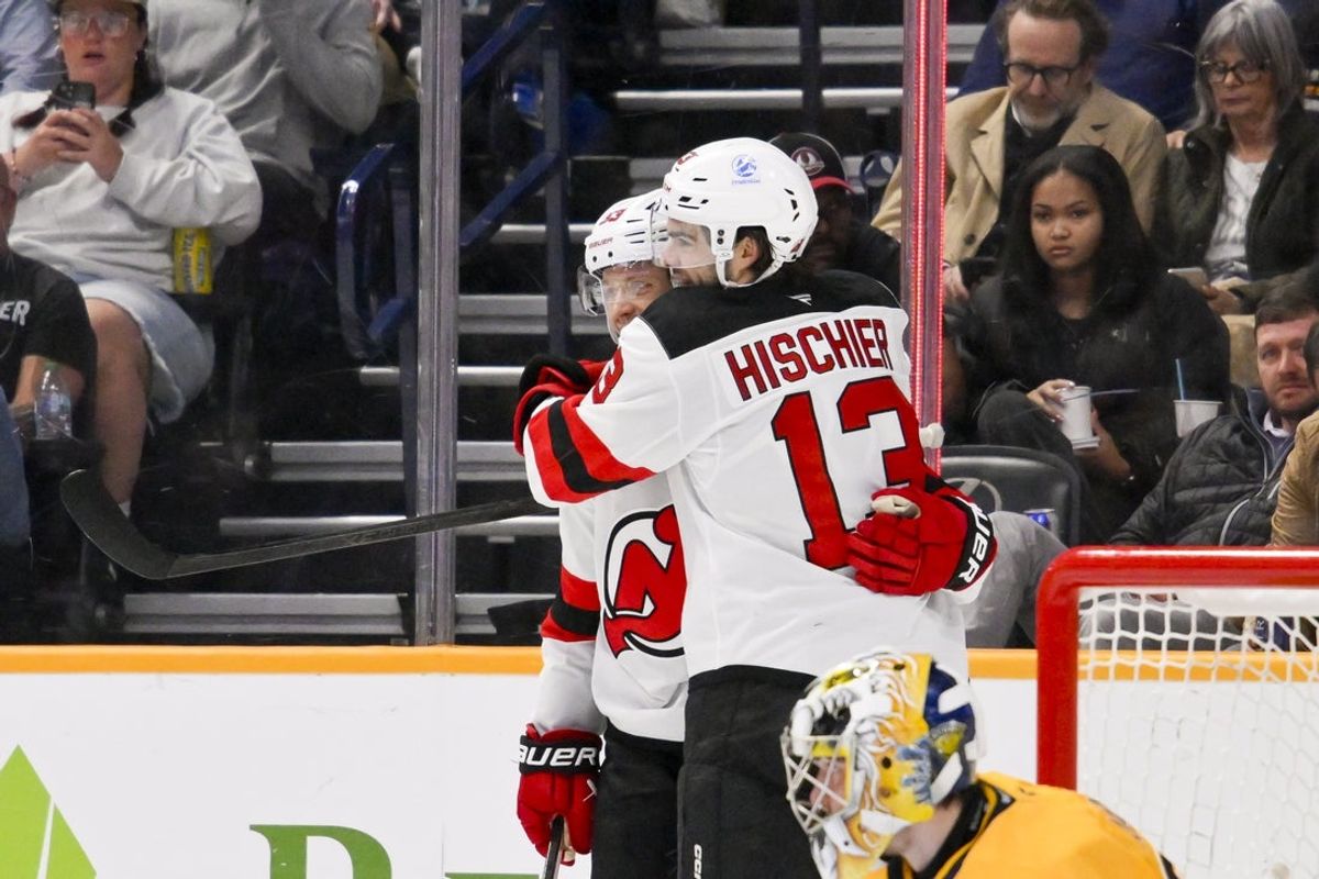 Mar 26, 2026; Nashville, Tennessee, USA;  New Jersey Devils center Nico Hischier (13) celebrates the goal of left wing Jesper Bratt (63) against the Nashville Predators during the second period at Bridgestone Arena. Mandatory Credit: Steve Roberts-Imagn Images