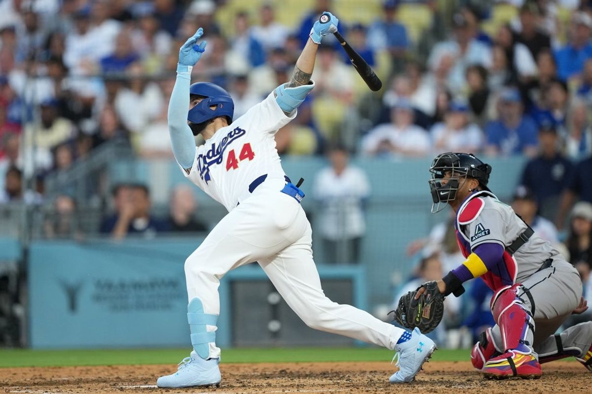 Mar 26, 2026; Los Angeles, California, USA; Los Angeles Dodgers outfielder Andy Pages (44) hits a 400 foot three run home run to left center field as Arizona Diamondbacks catcher Gabriel Moreno (14) watches the play during the fifth inning at Dodger Stadium. Mandatory Credit: Kirby Lee-Imagn Images
