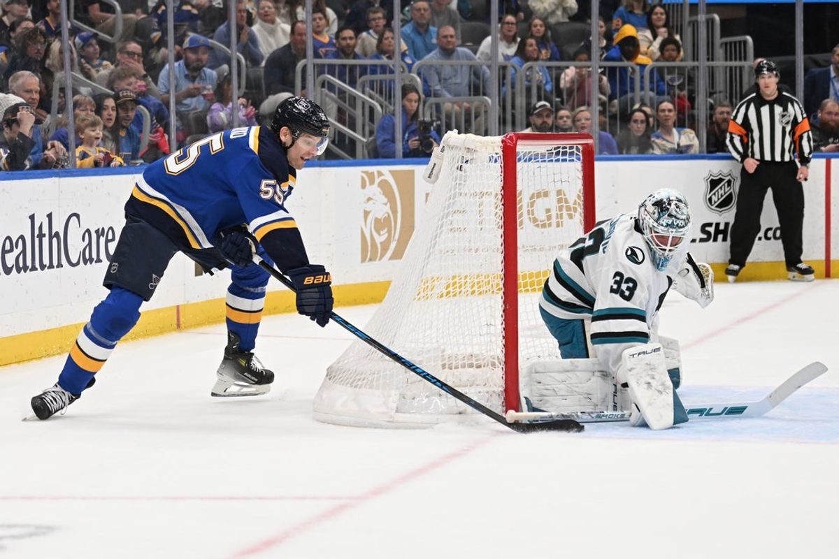 Mar 26, 2026; St. Louis, Missouri, USA; San Jose Sharks goaltender Alex Nedeljkovic (33) defends the net against St. Louis Blues defenseman Colton Parayko (55) in the second period at Enterprise Center. Mandatory Credit: Joe Puetz-Imagn Images