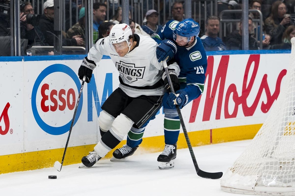 Mar 26, 2026; Vancouver, British Columbia, CAN; Vancouver Canucks defenseman Marcus Pettersson (29) checks Los Angeles Kings forward Trevor Moore (12) in the first period at Rogers Arena. Mandatory Credit: Bob Frid-Imagn Images
