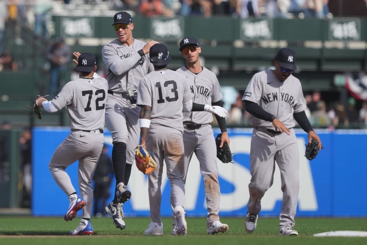 Mar 27, 2026; San Francisco, California, USA; New York Yankees right fielder Aaron Judge (second from left) celebrates with shortstop Jose Caballero (72) after defeating the San Francisco Giants at Oracle Park. Mandatory Credit: Darren Yamashita-Imagn Images