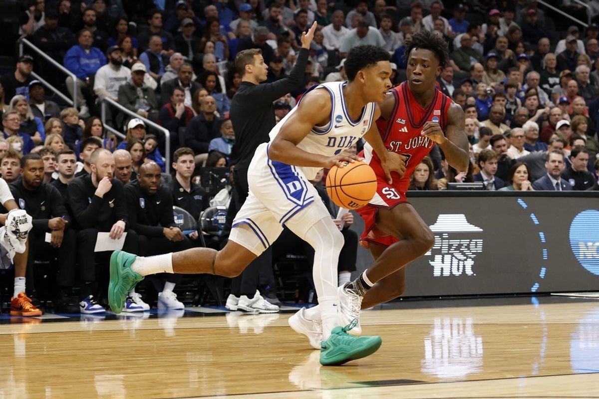 Mar 27, 2026; Washington, DC, USA; Duke Blue Devils guard Caleb Foster (1) dribbles the ball past St. John's Red Storm guard Joson Sanon (3) in the first half during a Sweet Sixteen game of the East Regional of the men's 2026 NCAA Tournament at Capital One Arena. Mandatory Credit: Geoff Burke-Imagn Images