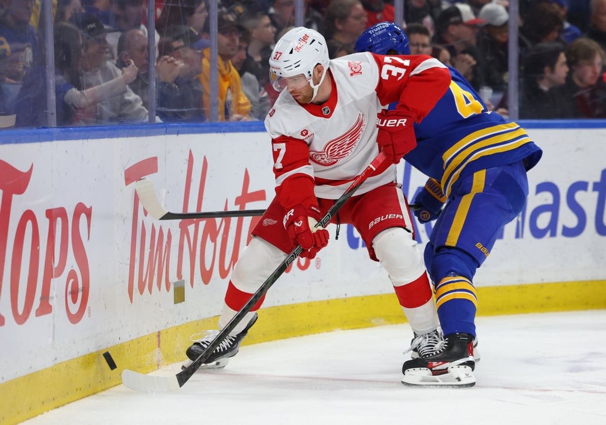 Mar 27, 2026; Buffalo, New York, USA;  d32 and Buffalo Sabres center Josh Dunne (44) go after a loose puck during the first period at KeyBank Center. Mandatory Credit: Timothy T. Ludwig-Imagn Images