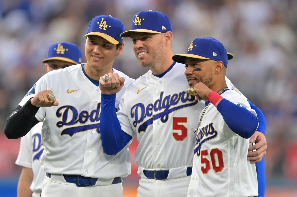 Mar 27, 2026; Los Angeles, California, USA; Los Angeles Dodgers two-way player Shohei Ohtani (17) poses with first baseman Freddie Freeman (5) and shortstop Mookie Betts (50) during the World Series ring ceremony before the game against the Arizona Diamondbacks at Dodger Stadium. Mandatory Credit: Jayne Kamin-Oncea-Imagn Images