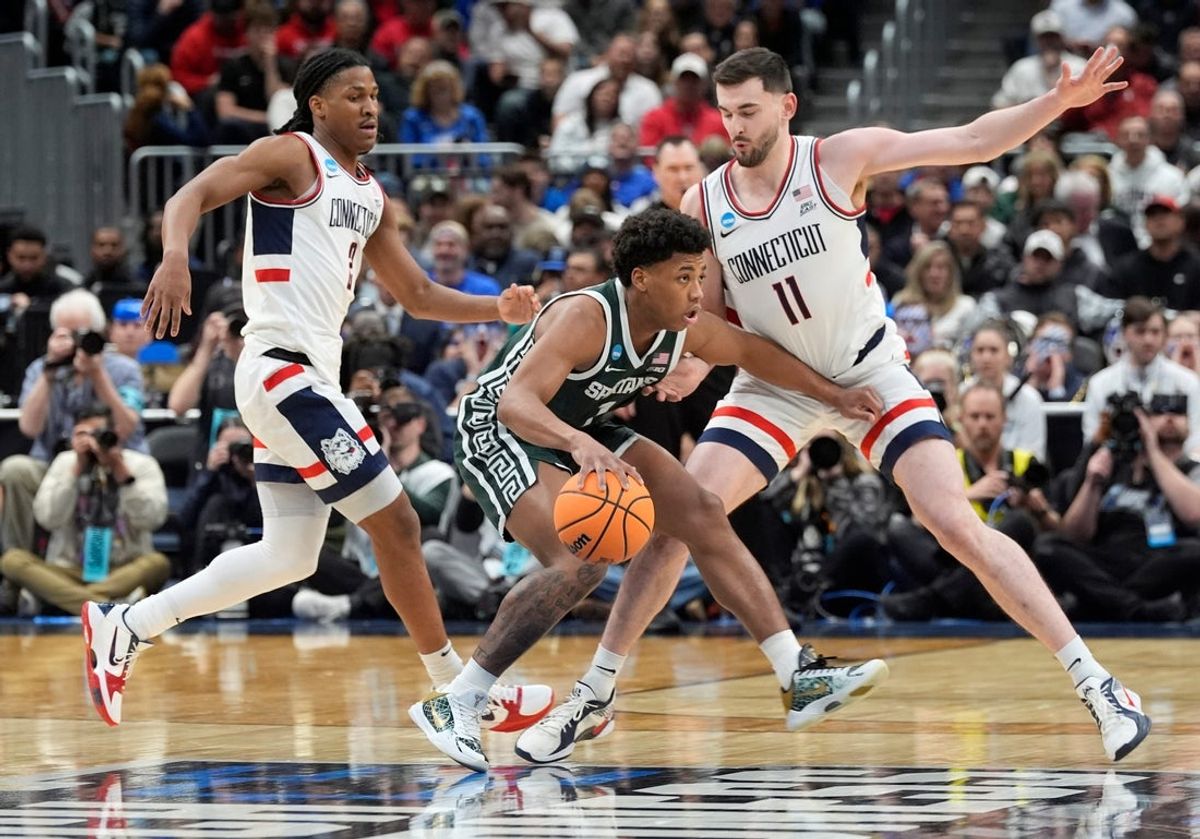 Michigan State guard Jeremy Fears Jr. (1) tries to get around the defense of Connecticut forward Alex Karaban (11) during the first half of the 2026 NCAA Men's Basketball East Regional game against UConn at Capital One Arena in Washington DC on Friday, March 27, 2026.