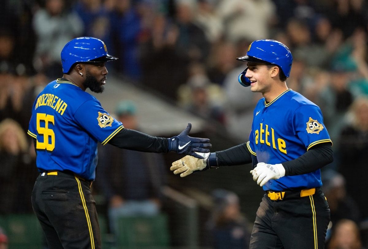 Mar 27, 2026; Seattle, Washington, USA; Seattle Mariners second baseman Cole Young (2) is congratulated byleft fielder Randy Arozarena (56) after hitting as three-run home run during the fourth inning against the Cleveland Guardians at T-Mobile Park. Mandatory Credit: Stephen Brashear-Imagn Images