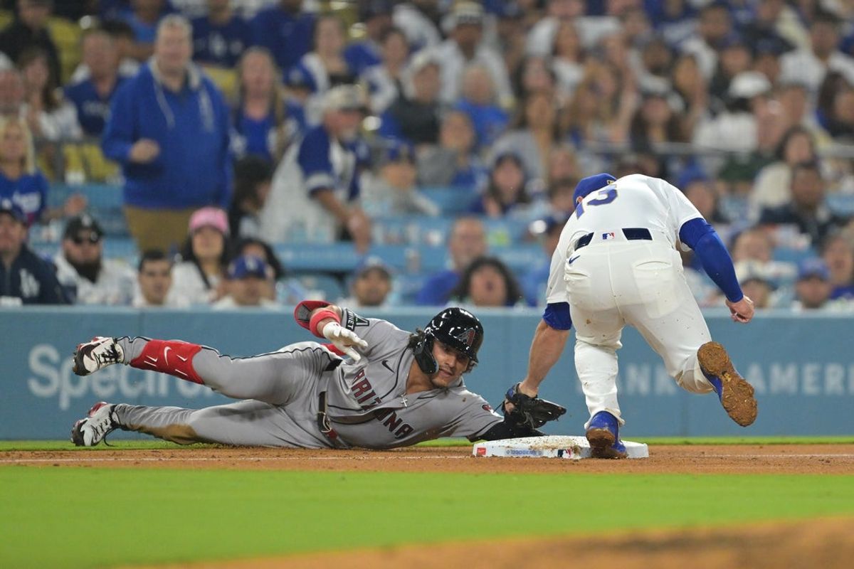 Mar 27, 2026; Los Angeles, California, USA; Arizona Diamondbacks center fielder Alek Thomas (5) is out against Los Angeles Dodgers third baseman Max Muncy (13) in the fourth inning at Dodger Stadium. Mandatory Credit: Jayne Kamin-Oncea-Imagn Images
