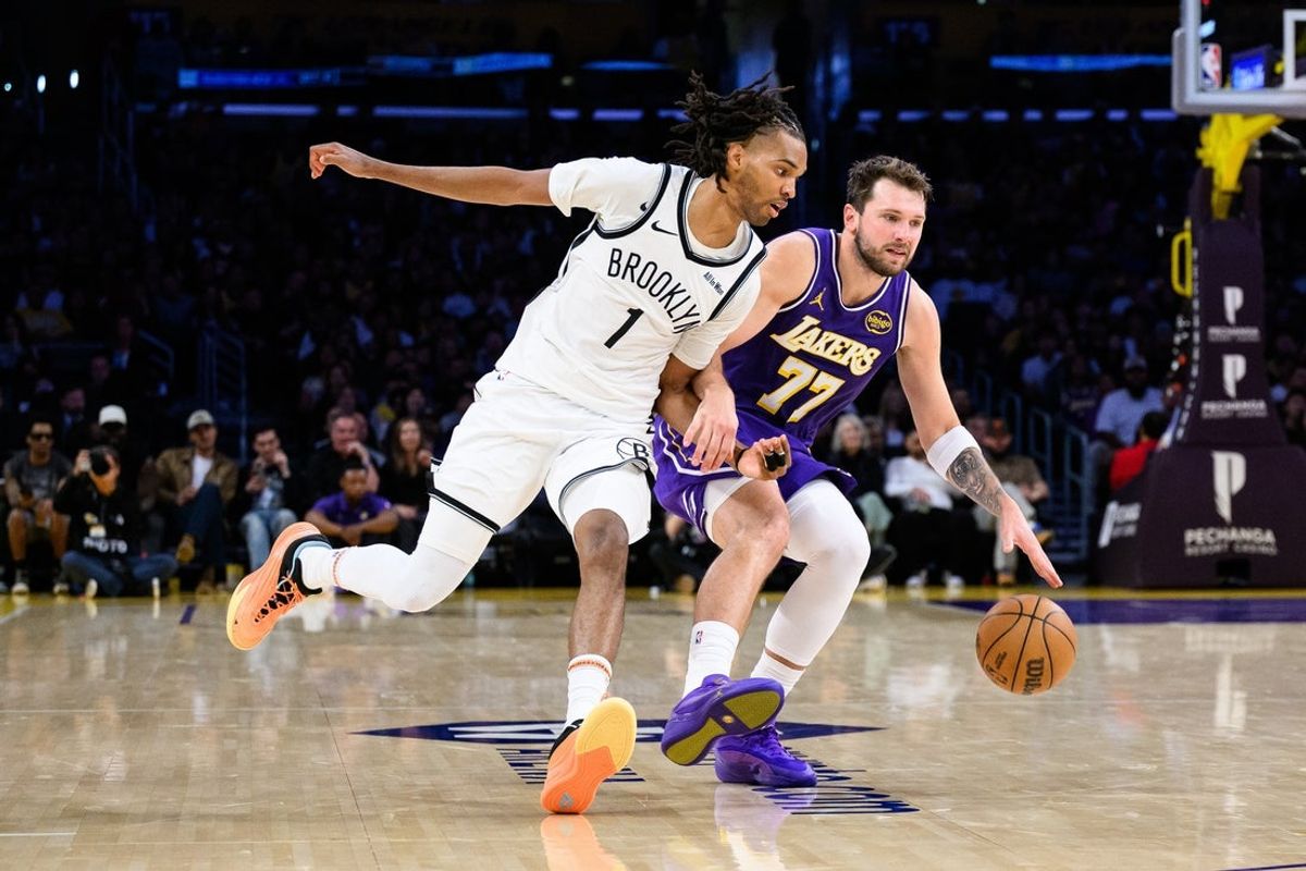 Mar 27, 2026; Los Angeles, California, USA; Los Angeles Lakers guard Luka Doncic (77) drives against Brooklyn Nets forward Ziaire Williams (1) during the second half at Crypto.com Arena. Mandatory Credit: William Liang-Imagn Images