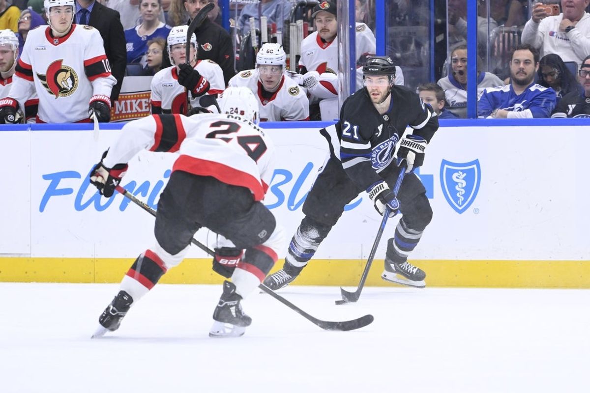Mar 28, 2026; Tampa, Florida, USA; Tampa Bay Lighting center Brayden Point (21) skates next to Ottawa Senators center Dylan Cozens (24) during first period at Benchmark International Arena. Mandatory Credit: Pablo Robles-Imagn Images