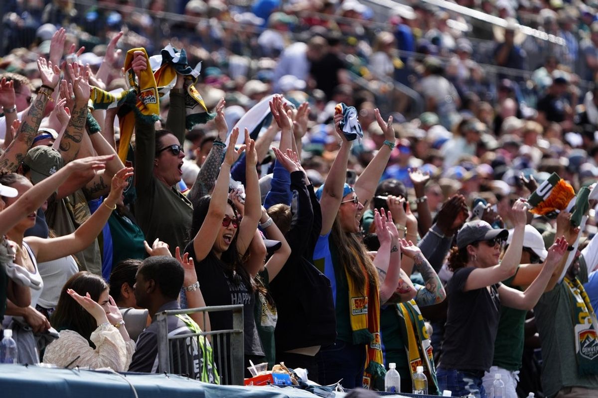 Mar 28, 2026; Denver, Colorado, USA; Denver Summit FC fans cheer during the match against the Washington Spirit at Empower Field at Mile High. Mandatory Credit: Ron Chenoy-Imagn Images