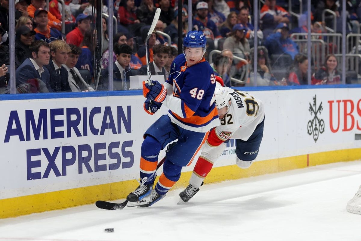 Mar 28, 2026; Elmont, New York, USA; New York Islanders defenseman Matthew Schaefer (48) plays the puck against Florida Panthers left wing Tomas Nosek (92) during the third period at UBS Arena. Mandatory Credit: Brad Penner-Imagn Images