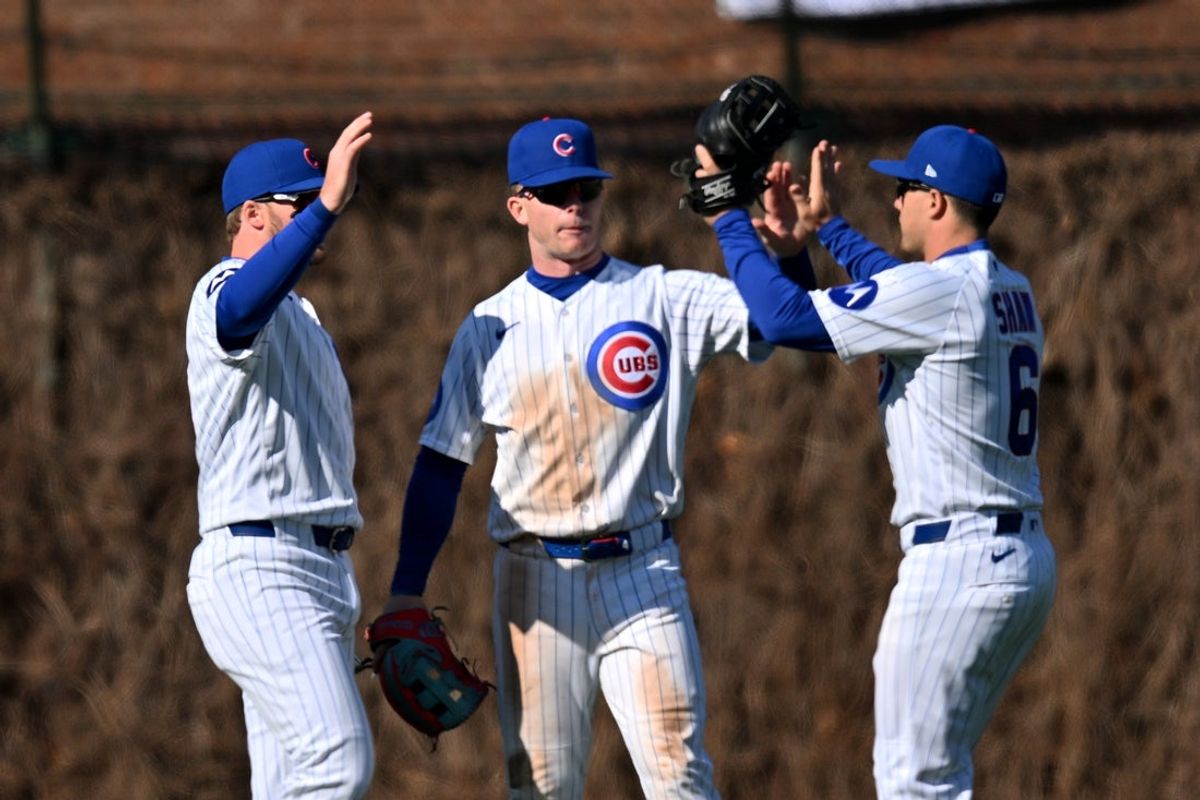 Mar 28, 2026; Chicago, Illinois, USA; Chicago Cubs left fielder Ian Happ (8), center fielder Pete Crow-Armstrong (4) and right fielder Matt Shaw (6) celebrate after defeating the Washington Nationals at Wrigley Field. Mandatory Credit: Patrick Gorski-Imagn Images