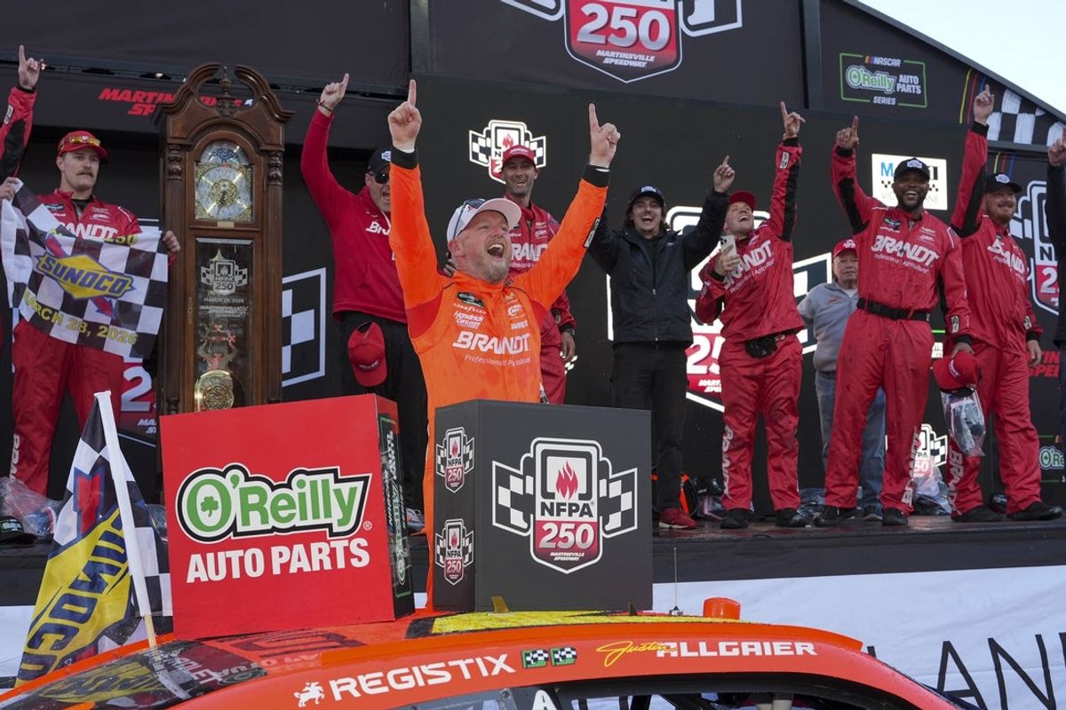 Mar 28, 2026; Martinsville, Virginia, USA;  JR Motorsports driver Justin Allgaier (7) celebrates his win with his crew after the race at Martinsville Speedway. Mandatory Credit: Jim Dedmon-Imagn Images